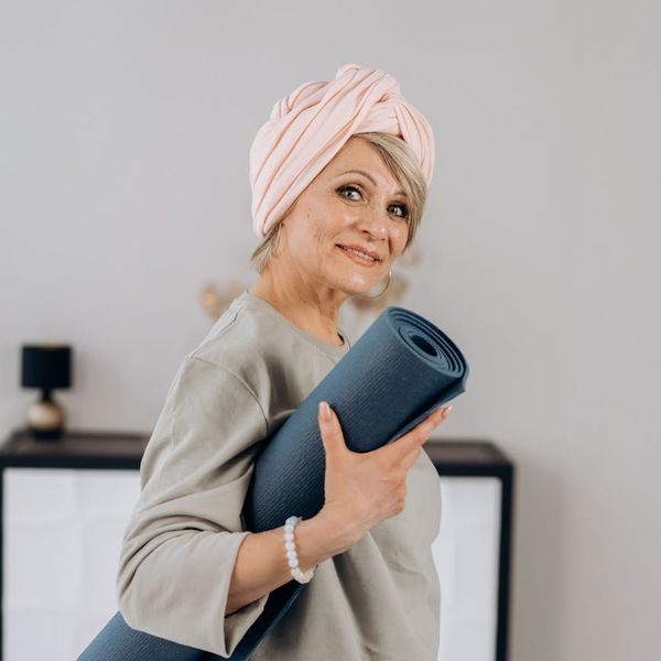 Smiling person in comfortable clothing after a yoga session.